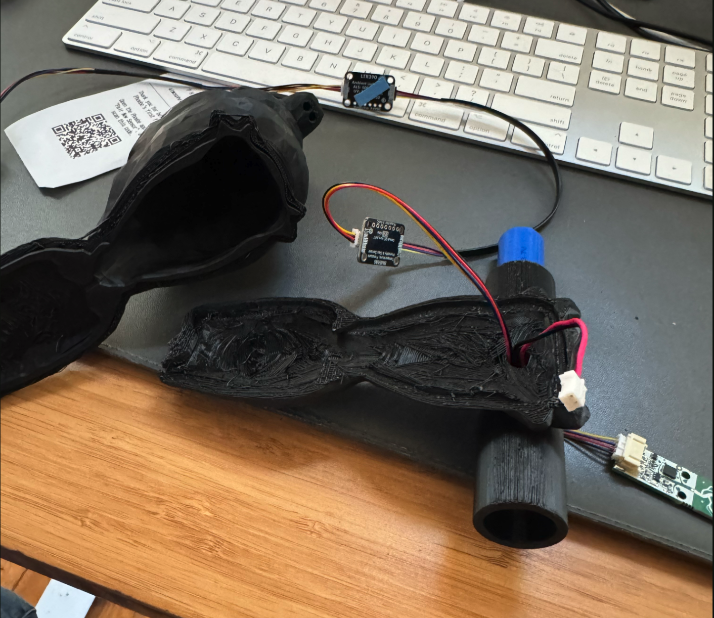 Latest bird print on desk with breakout boards and wires stuffed inside, connected to the Perch tube